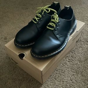 Low top black Dr Martens boots with green laces. Laces came with the boots.